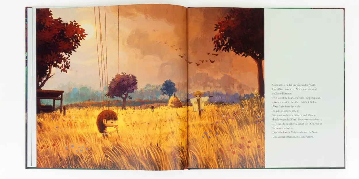 An open spread from the book: Abby in a golden field beside a tree and a swing