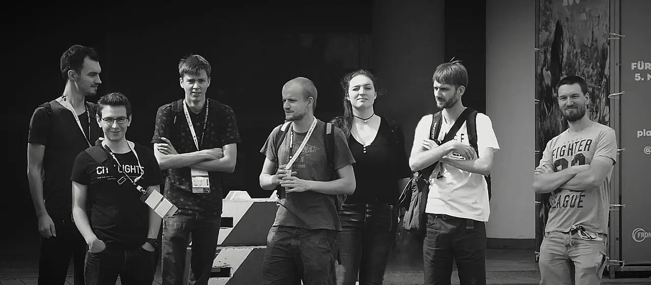 Black-and-white photo of the team at a games event, wearing lanyards
